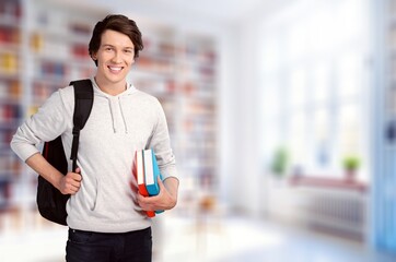 Portrait of smart teenage boy hold book