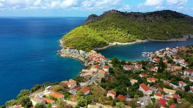 Assos village in Kefalonia, Greece. Turquoise colored bay in Mediterranean sea with beautiful colorful houses in Assos village in Kefalonia, Greece, Ionian island, Cephalonia, Assos village.