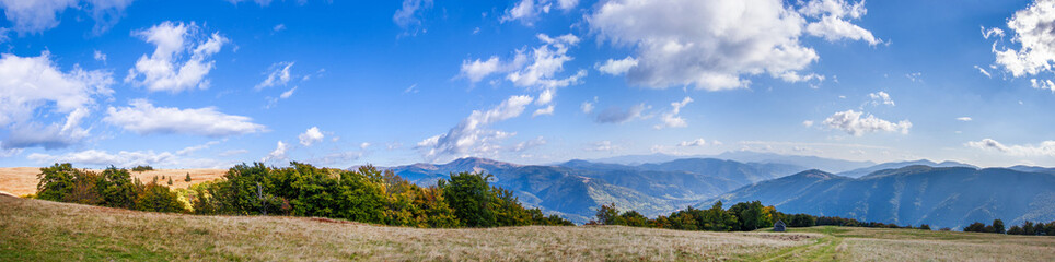 Stunning panorama of the Carpathian mountains on a sunny autumn day. The village of Kvasy can be seen in the distance. Carpathians, Ukraine