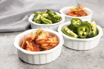 Bowls of kimchi and peppers.
