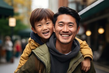 Happy Asian father and son smiling together outdoors