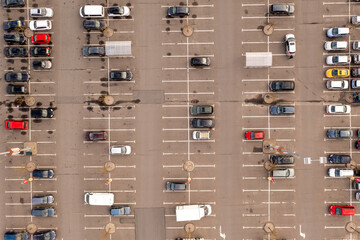 Drone photography of a large semi full parking lot near a shopping mall during autumn day