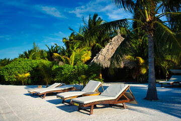 Lounge chairs on the beach in Mexico Caribbean sea
