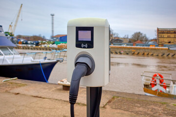 Battery charger at the water's edge in the port. Selective focus.