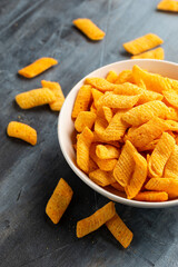 Crunchy Nacho cheese corn snack in white bowl