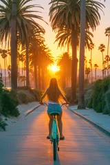 Papier Peint photo Descente vers la plage A girl riding a colorful beach cruiser bike along a palm tree-lined boardwalk, with the sun setting behind her
