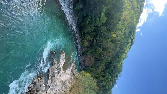 The Bolshaya Laba River. A mountain emerald river in a narrow, sunlit canyon. Bolshaya Laba River near the village of Psemen in Karachay-Cherkessia, Russia. Panoramic view. 4K
