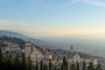 Fototapeta na wymiar Amazing panorama view of Assisi, province of Umbria city skyline and skyscraper at sunset. Beautiful view from hill, seen St. Francis church or Basilica and hill in background. High quality photo