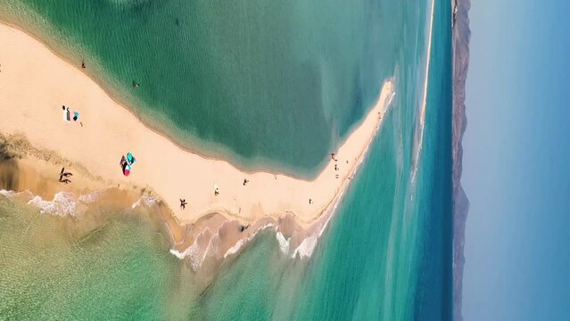 Aerial view of golden sand and crystal sea water on the Canary. Aerial vertical, vertical video background.