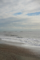Seascape view Panorama beach, sandy coastline with white foamy sea water. Close up waves splashing on beach background. 
