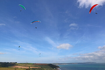 Paragliders flying above Beesands in Devon	