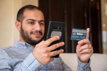 muslim man paying online through mobile phone application