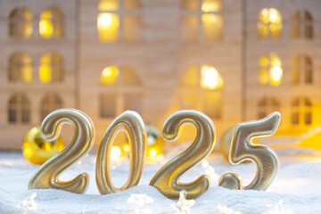Golden figures number 2025 against the background of cozy windows of a house with warm light with festive decor of stars,snow and garlands. Greeting card, Happy New Year, cozy home