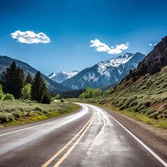 Fototapeta premium Scenic mountain road with snow capped mountains in the distance