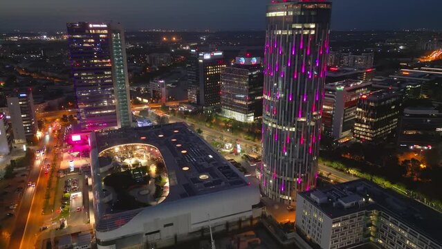 Aerial Reveal Shot Of Bucharest City Skyline Financial District Illuminated At Night