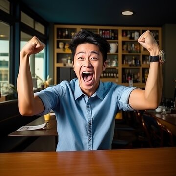 Ecstatic Asian man celebrating his success