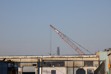 a crane is in the background above a parking lot with many buildings