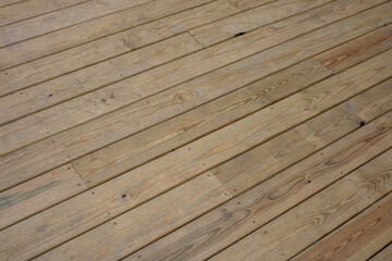 a small skate board sitting on a wooden deck next to a bench