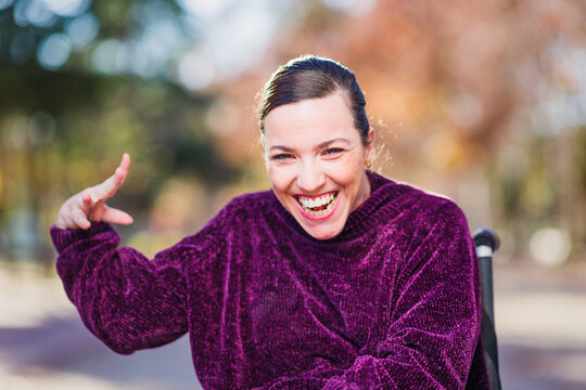 Hispanic Woman with cerebral palsy disability diversity, Portrait waving and greeting to camera