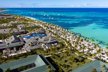 Obraz premium Tropical beach with resorts, palm trees and caribbean sea. Dominican Republic. Aerial view