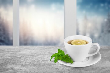 A cup of tasty hot tea on the windowsill