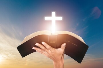 Dramatic Christian Cross light and Bible book