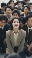 Young Asian businesswoman smiling at a group of people