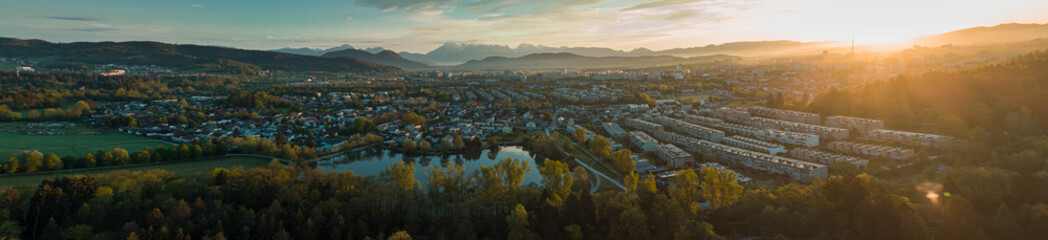Early morning panorama of Koseze pond or koseski bajer with a modern city hlock on the right. Picturesque morning of siska, a ljubljana suburb. Sun just rising up. - obrazy, fototapety, plakaty