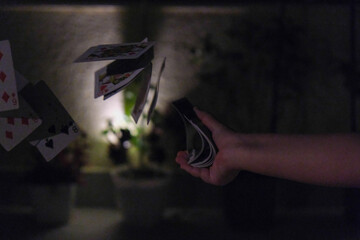 Playing cards fall on a gray backgraund.