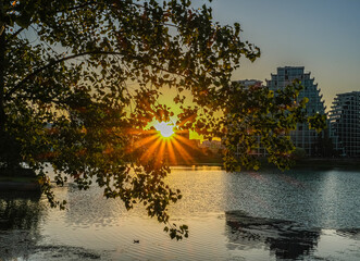Bright sunset over lake Tirana, Albania golden clouds reflect in the water