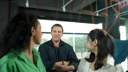 Portrait of professional diverse business team brainstorming marketing idea on colorful sticky...
