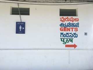 Gents Toilet signage in multiple languages in India. Washroom signs and directions indicate the...