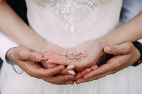 The image depicts a person wearing a wedding dress and holding their hands together, possibly displaying a wedding