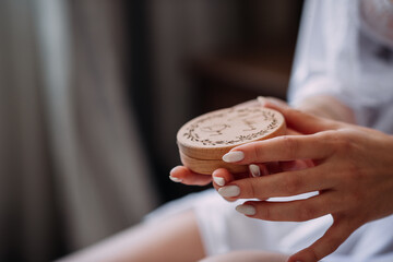 The image is not available to me, but based on the description, it depicts a person holding a stack...