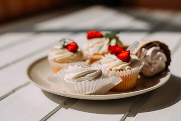 The image is of a plate of dessert featuring a strawberry pastry with cream and icing 5279.
