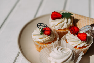 The image is a plate of cupcakes topped with strawberries and cream 5278.