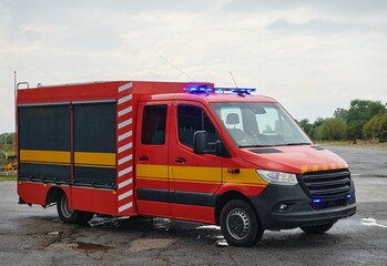 Fototapeta na wymiar A state-of-the-art firetruck, equipped with advanced rescue technology, stands ready with its skilled firefighting team, prepared to intervene and respond rapidly to emergencies, ensuring the safety