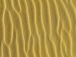Fototapeta na wymiar wave sand texture, desert background sandy beach