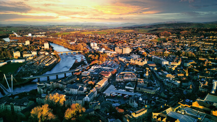 Aerial view of a city Lancaster at sunset with warm lighting, showcasing the urban landscape,...