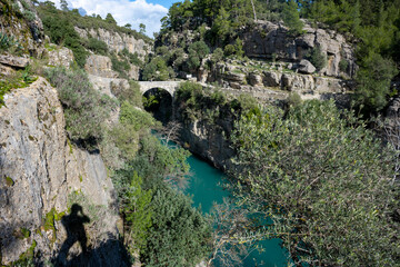 Fototapeta na wymiar Transparent waters of Kopru River (Köprüçay, ancient Eurymedon) with its emerald green colour in Koprulu Canyon (Köprülü Kanyon) National Park, Antalya, Turkey. It's a rafting paradise