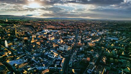 Aerial view of the Lancaster city at sunset with warm light casting over buildings and streets,...