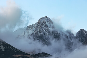 Lomnický Peak is one of the highest mountain peaks in the High Tatras mountains of Slovakia. The peak of the mountain is shrouded in clouds in the evening. There is an observatory on the rock.