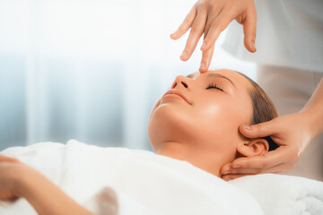 Caucasian woman enjoying relaxing anti-stress head massage and pampering facial beauty skin recreation leisure in dayspa modern light ambient at luxury resort or hotel spa salon. Quiescent - Powered by Adobe