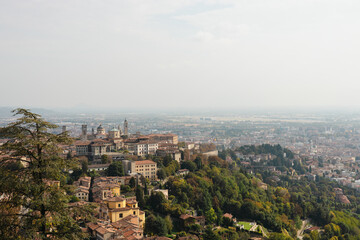 View at Old Town Citta Alta of Bergamo from San Vigilio Hill. Bergamo, Italy. Travel postcard