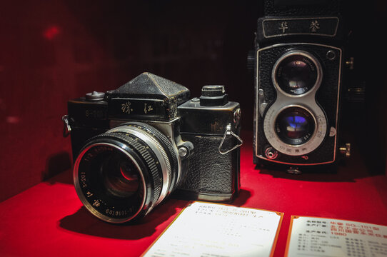 Shanghai, China - March 24, 2013: JHE JIANG or Pearl River S-201 SLR camera - on left - in Museum of Old Camera Manufacturing in Shanghai