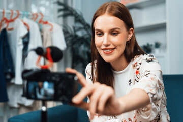 Fototapeta na wymiar Woman influencer shoot live streaming vlog video review makeup utmost social media or blog. Happy young girl with cosmetics studio lighting for marketing recording session broadcasting online.