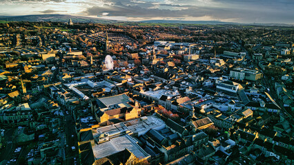 Aerial view of a city Lancaster at sunset with warm lighting highlighting the buildings and...