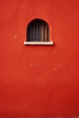 Small window on a red wall