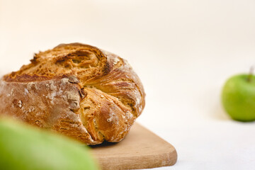 A delicious pie with a crispy golden crust. Comfort and delicious aroma. Green apples. Delicious treat