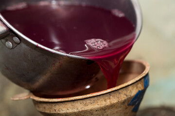 Wine making. Fresh grape juice is poured through a funnel into a barrel. Harvest home. Technology of wine production in Moldova.